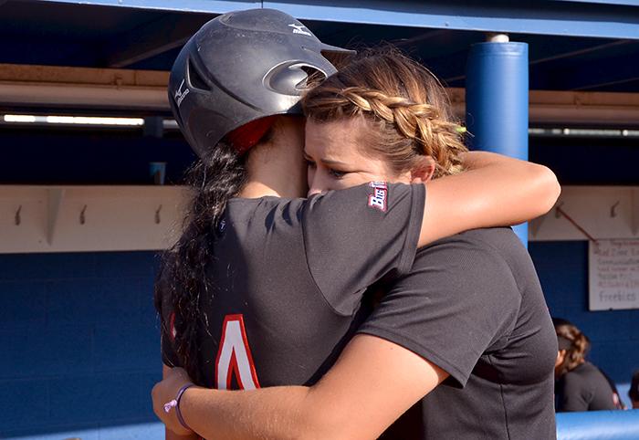 Senior Briana Elder and sophomore Nate Taylor console each other after the loss and elimination from the 2015 NCAA softball tournament by a final score of 5-4 to San Diego State University at Easton Stadium in Los Angeles, Calif., on Sat. May 16, 2015. (Raul Martinez/ The Sundial) 