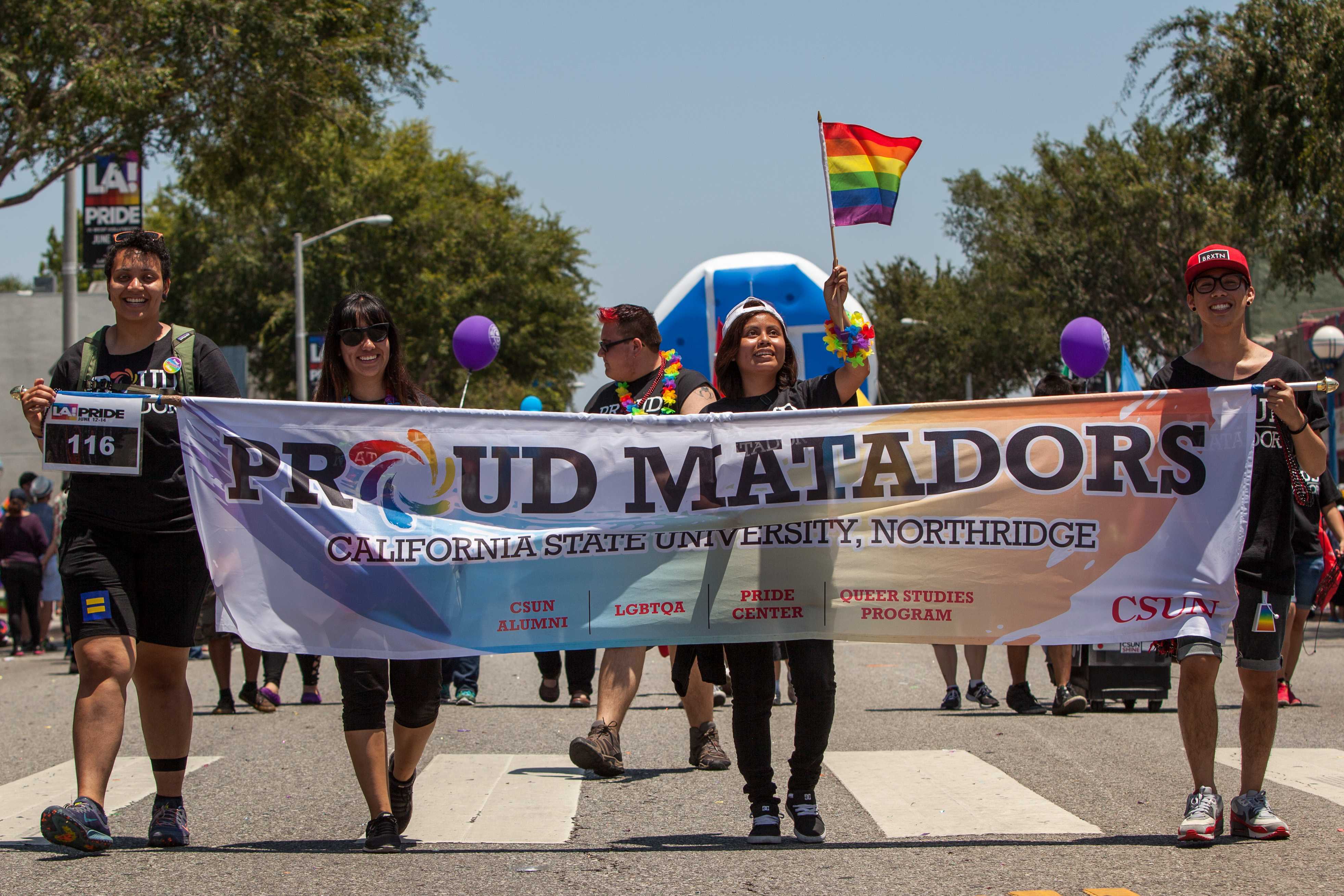 From left, Michelle Jones, Rosa Rodriguez, Little Jack and Jarred Gonzaga carry the Pride Center banner along the parade route. 

The Los Angeles PRIDE Parade was held on June 14, 2015 traveling Santa Monica Blvd. in West Hollywood, Calif. Photo credit: Matt Rose