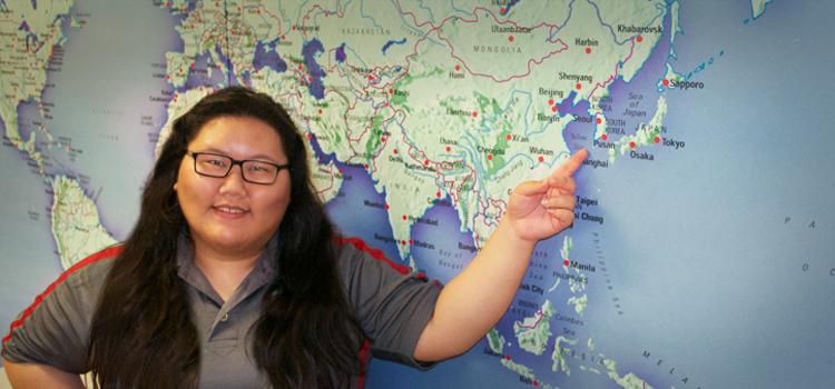 Kathleen Tuntisukharom, 22, points to Seoul, South Korea on the map in the International and Exchange Student Center on campus. This is where she will study abroad starting Fall 2015. Photo credit: Alyson Burton