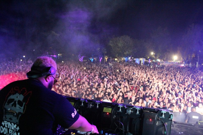 DJ preforms on stage in front of crowd on CSUN campus.