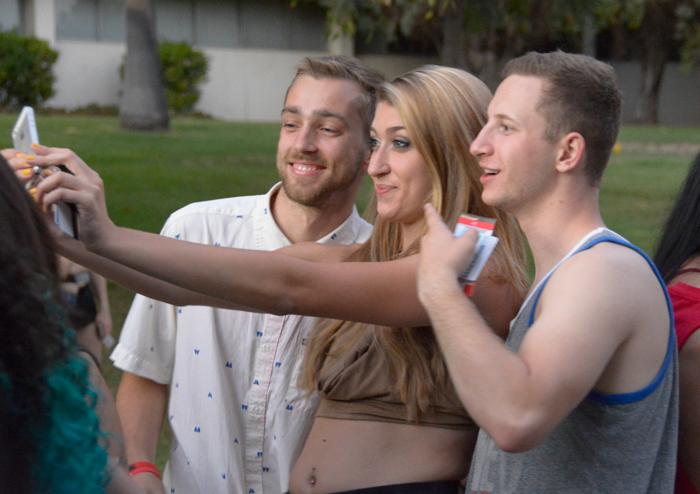Three CSUN pose for a selfie while waiting in line to enter Big Show.