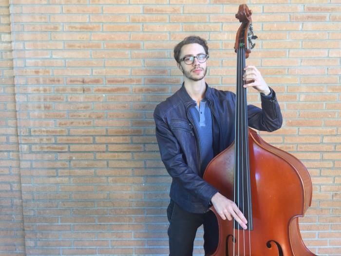 Daniel Massey shows off how he plays his upright bass.