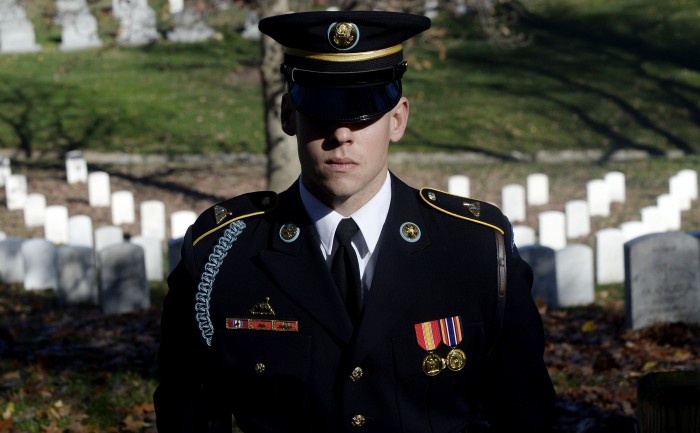 An Honor guard stands still as the motorcade carrying U.S. President Barack Obama makes its way into Arlington National Cemetery, Nov. 11, 2015 in Arlington, Va. (Olivier Douliery/Abaca Press/TNS)