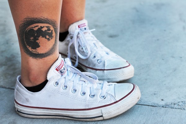 Melanie Moran,19, a Mechanical Engineer major, shows off her moon tattoo located on the bottom of her right calf. (Ashley Grant/ The Sundial)