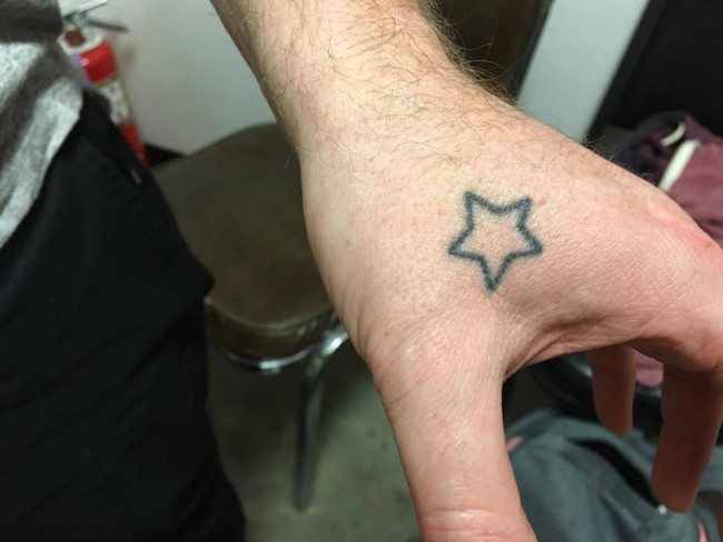 Cory Tatum, holds out his hand to show off the small star that connects him to his best friend.
