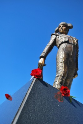Roses lie at the feet of the Matador Statue.   (Christianna Triolo/The Sundial)
