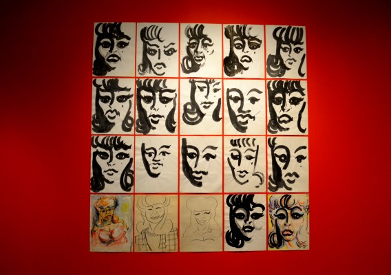 Rows of Montoyas studies of womens faces covers the back wall of the exhibition at the Fowler Museum. (Natalie Jimenez /The Sundial)