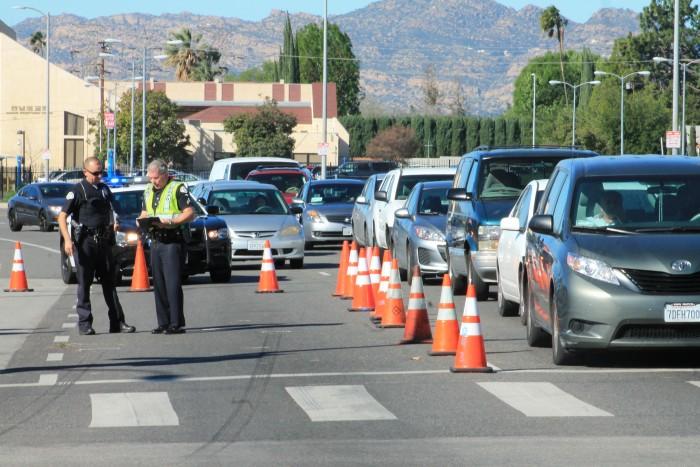 After a pursuit of a black Mercedes, cops used cones to block off lanes at the corner of Lassen and Zelzah causing traffic to build up around CSUN campus. (Ashley Grant / The Sundial)