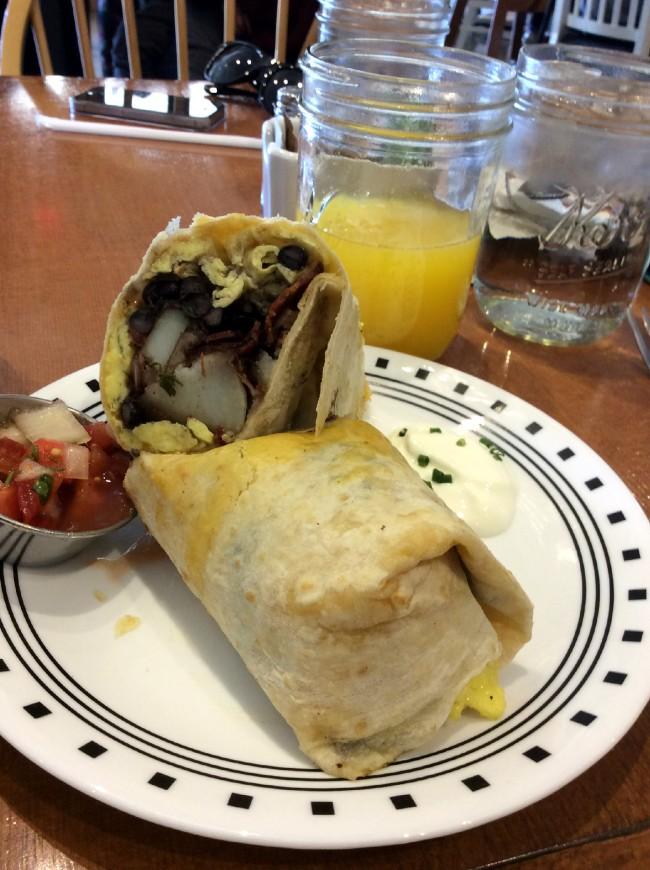 Breakfast burrito with potato, bacon, eggs, beans and cheese with house make pico de gallo and fresh squeezed orange juice at Humble Bee Bakery and Cafe. Photo credit: Genna Gold