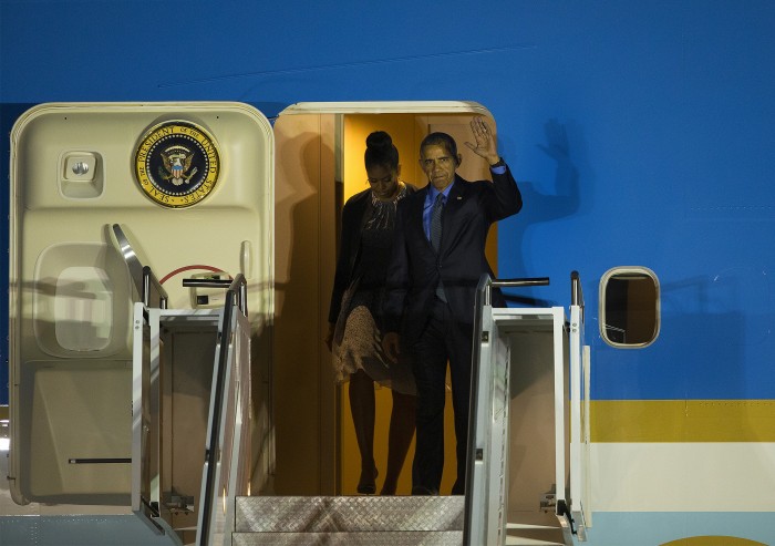 President Obama and first lady Michelle Obama depart Air Force One at San Bernardino International Airport to meet privately with the families of the victims of the San Bernardino terrorist attack, on Friday, Dec. 18, 2015. (Gina Ferazzi/Los Angeles Times/TNS)
