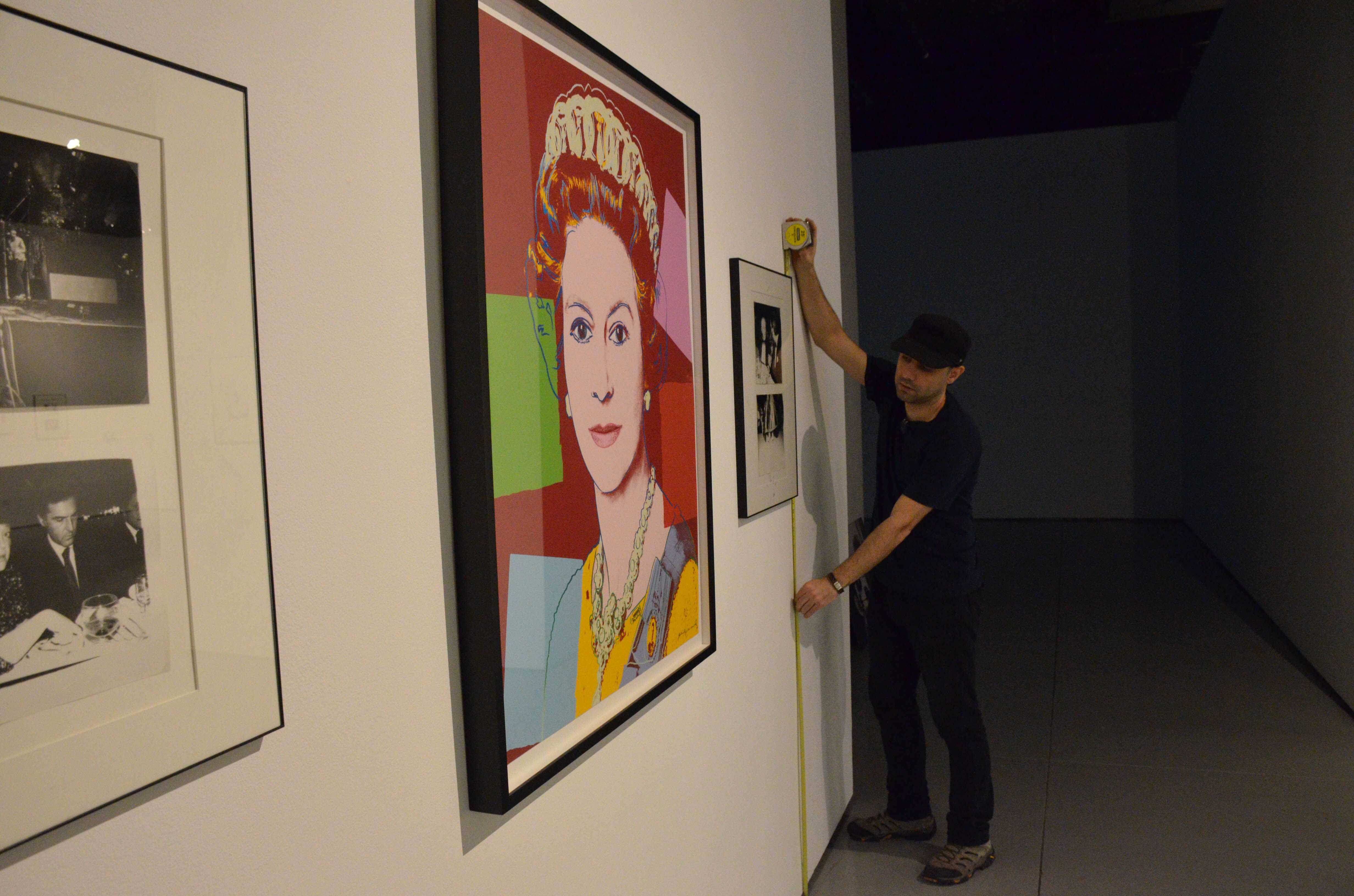 Mario Omid, a CSUN  graduate student and gallery assistant, helps set up the Main Gallery for the upcoming Andy Warhol exhibit.