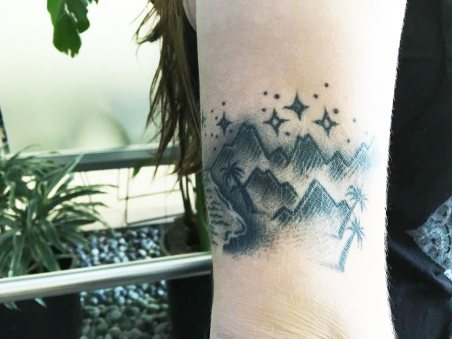 To show off her fondness for all of Earth's scenery, Brittany Huerta, got a detailed black and gray tattoo on her right arm. (Ashley Grant/ The Sundial)
