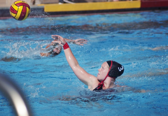 Student water polo athlete throws ball