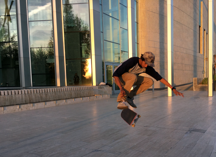 Mauricio Arana, from Patrick Henry Middle school, performing a hardflip in front of the VPAC before being told to leave the premises. (Patricia Perdomo / The Sundial)