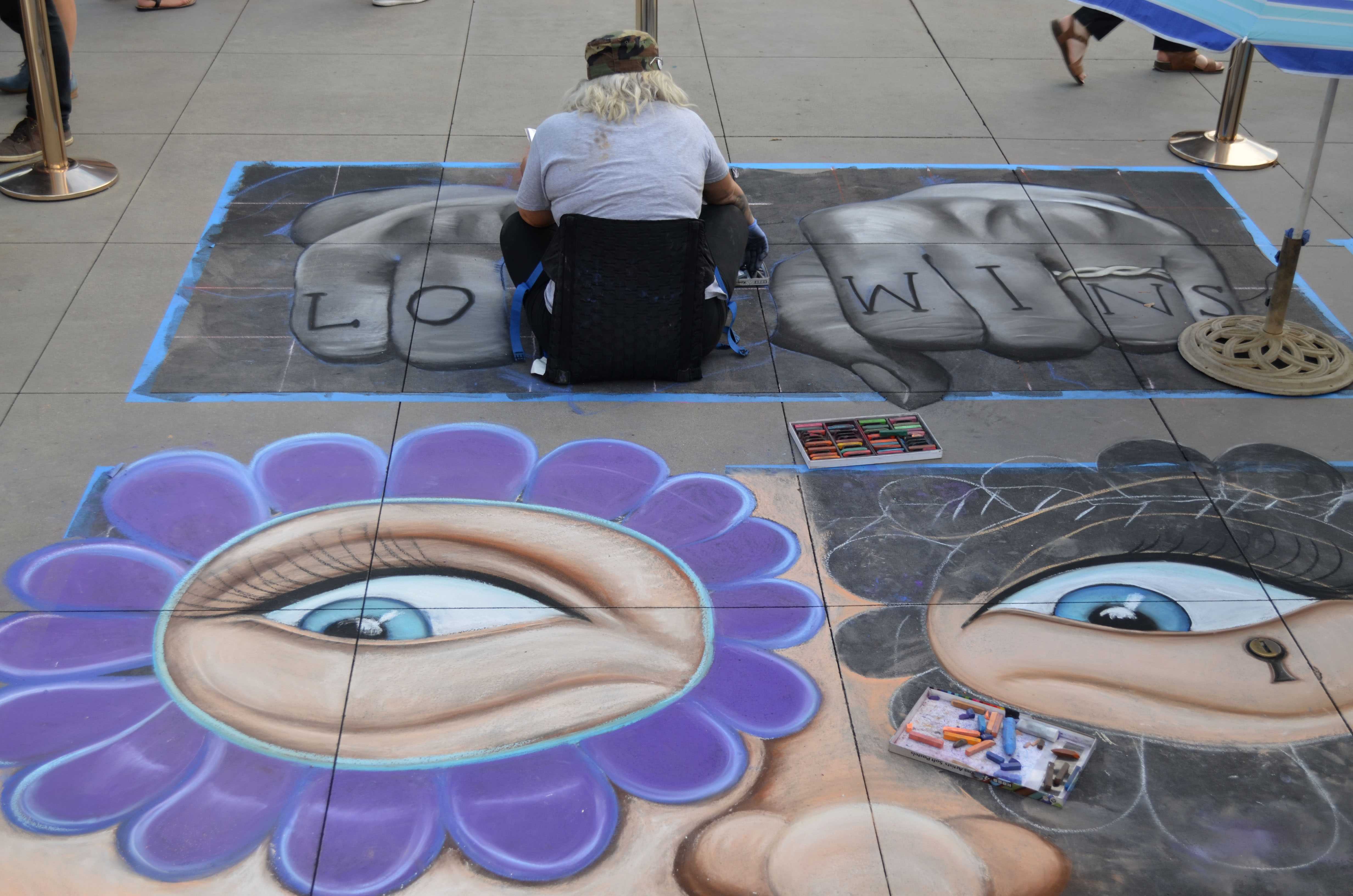 Woman makes chalk art that says, Love wins