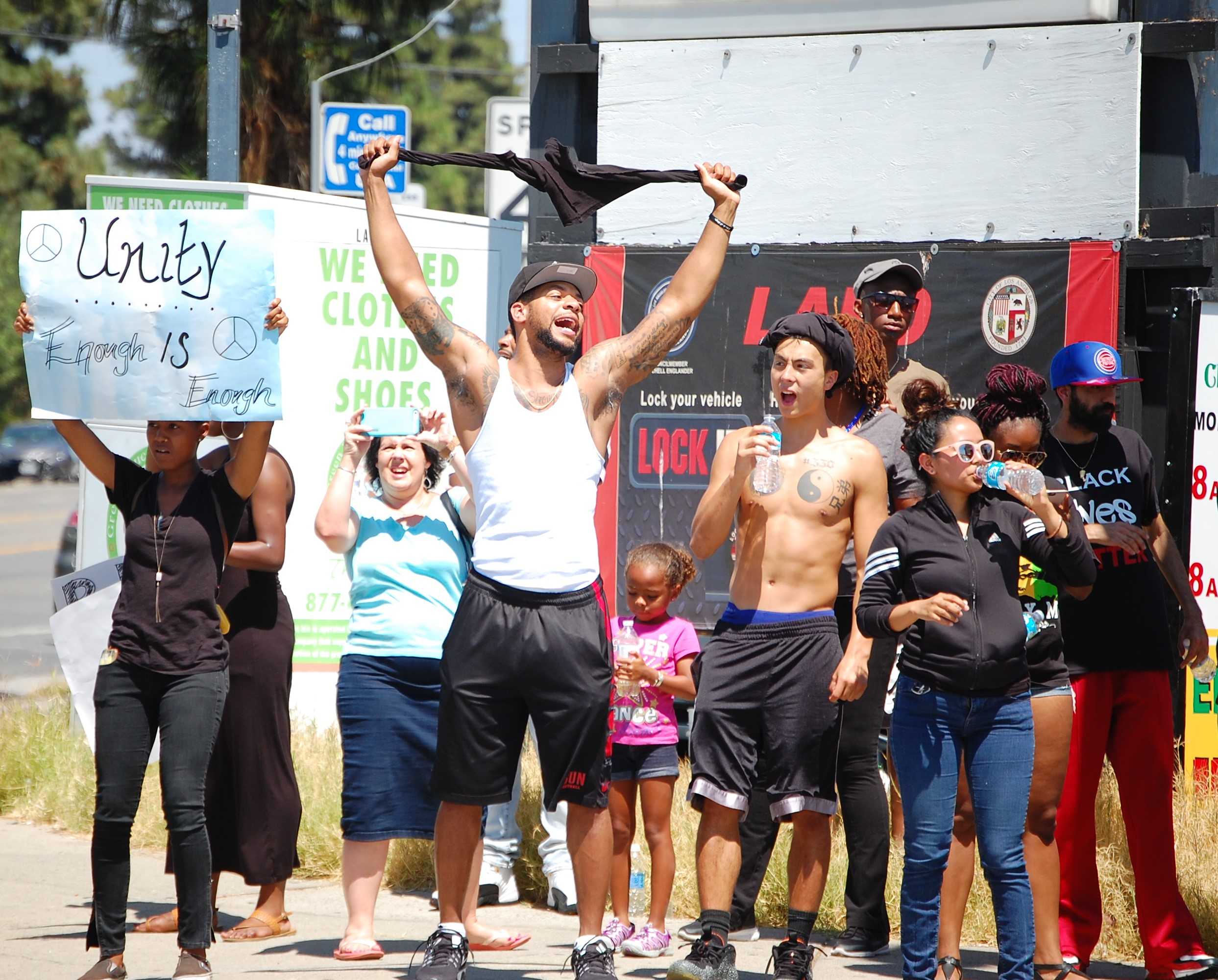 Protesters keep hydrated as they protest on the corner of Devonshire and Reseda Boulevard. (Josue Aguilar/The Sundial)