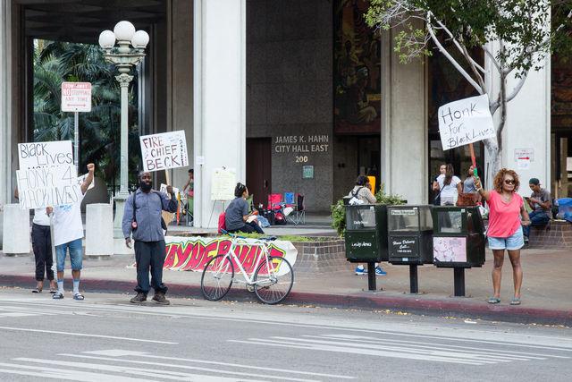 Protestors hold up signs outside of Los Angeles City Hall advocating for the resignation of LAPD Chief Charlie Beck. (Max Sullivan/The Sundial)