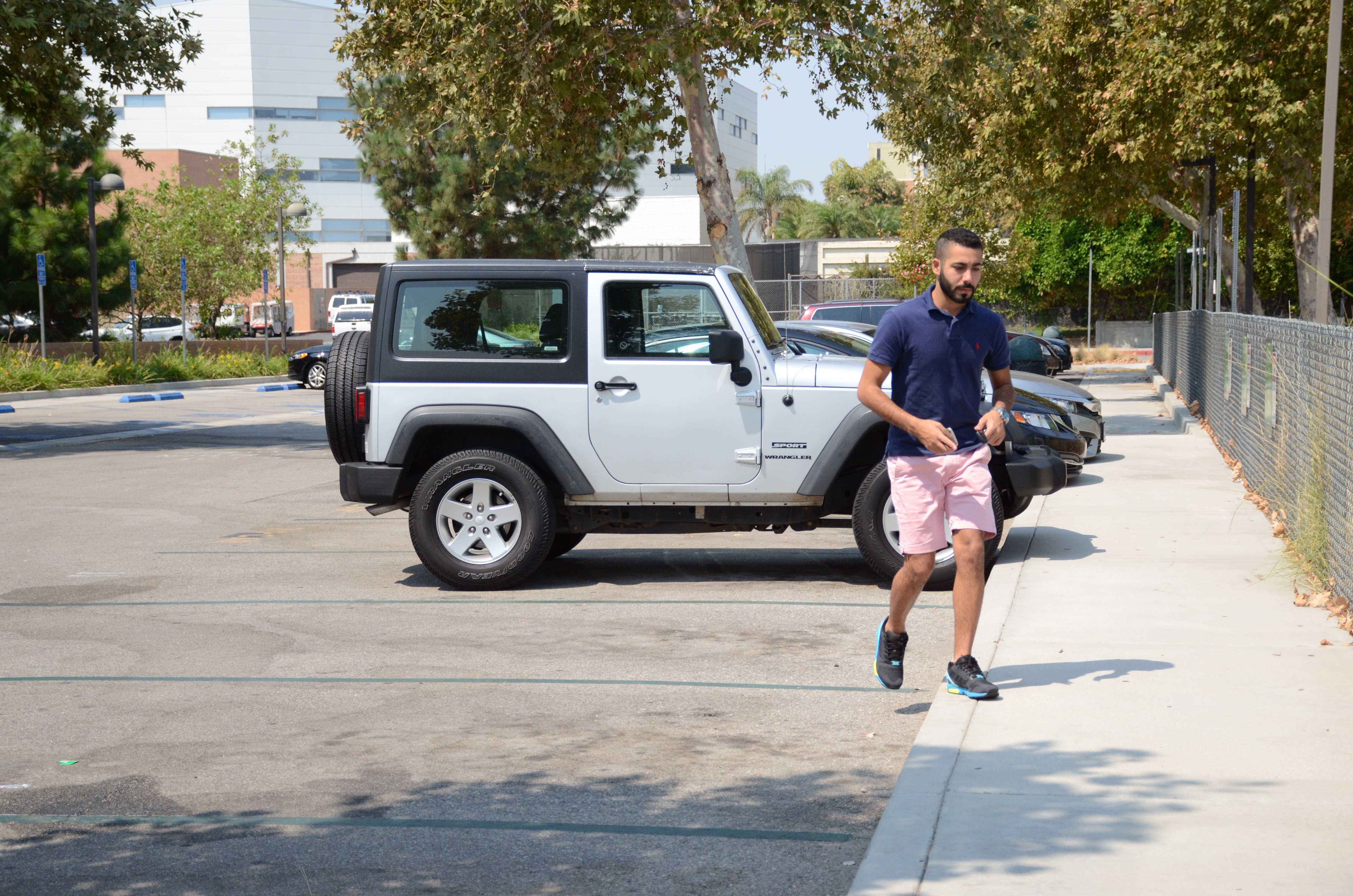 Student Khaled Alotaibi walks away from his car after parking near the Student Recreation Center on Thursday, August 25. Photo credit: Erik Luna