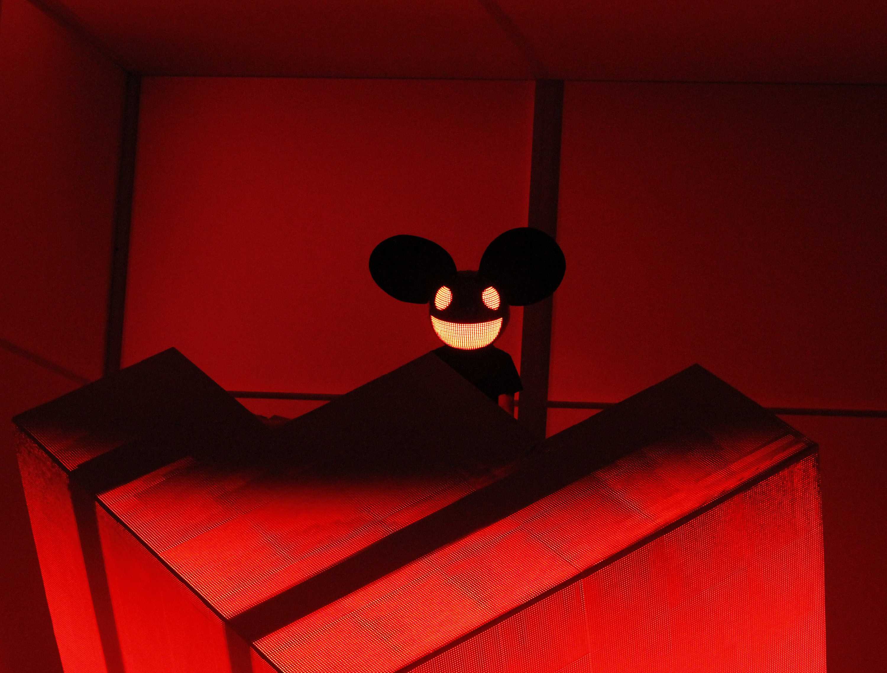 Picture of Deadmau5 performing with a red backdrop