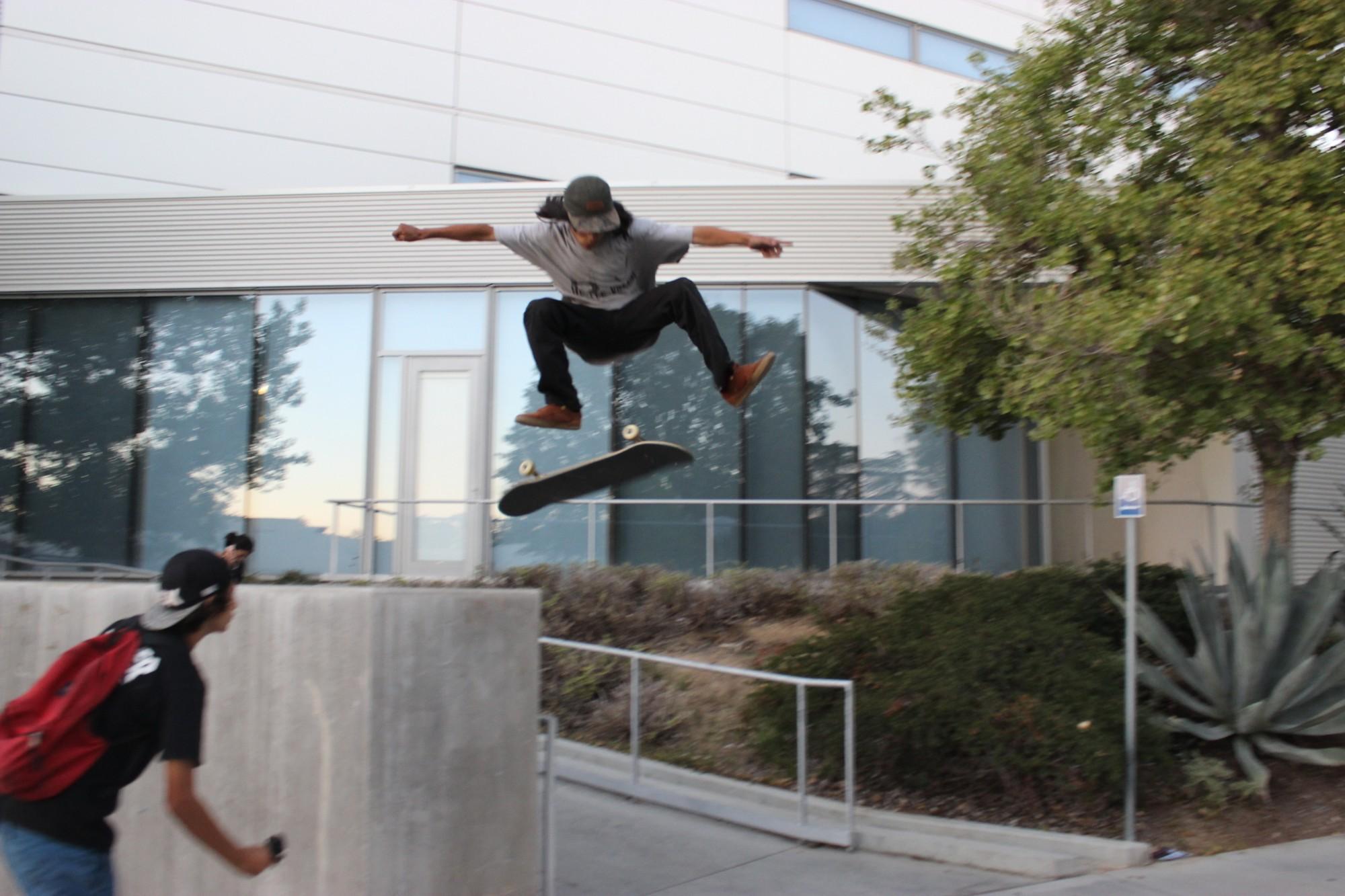 skateboarder attempts kickflip