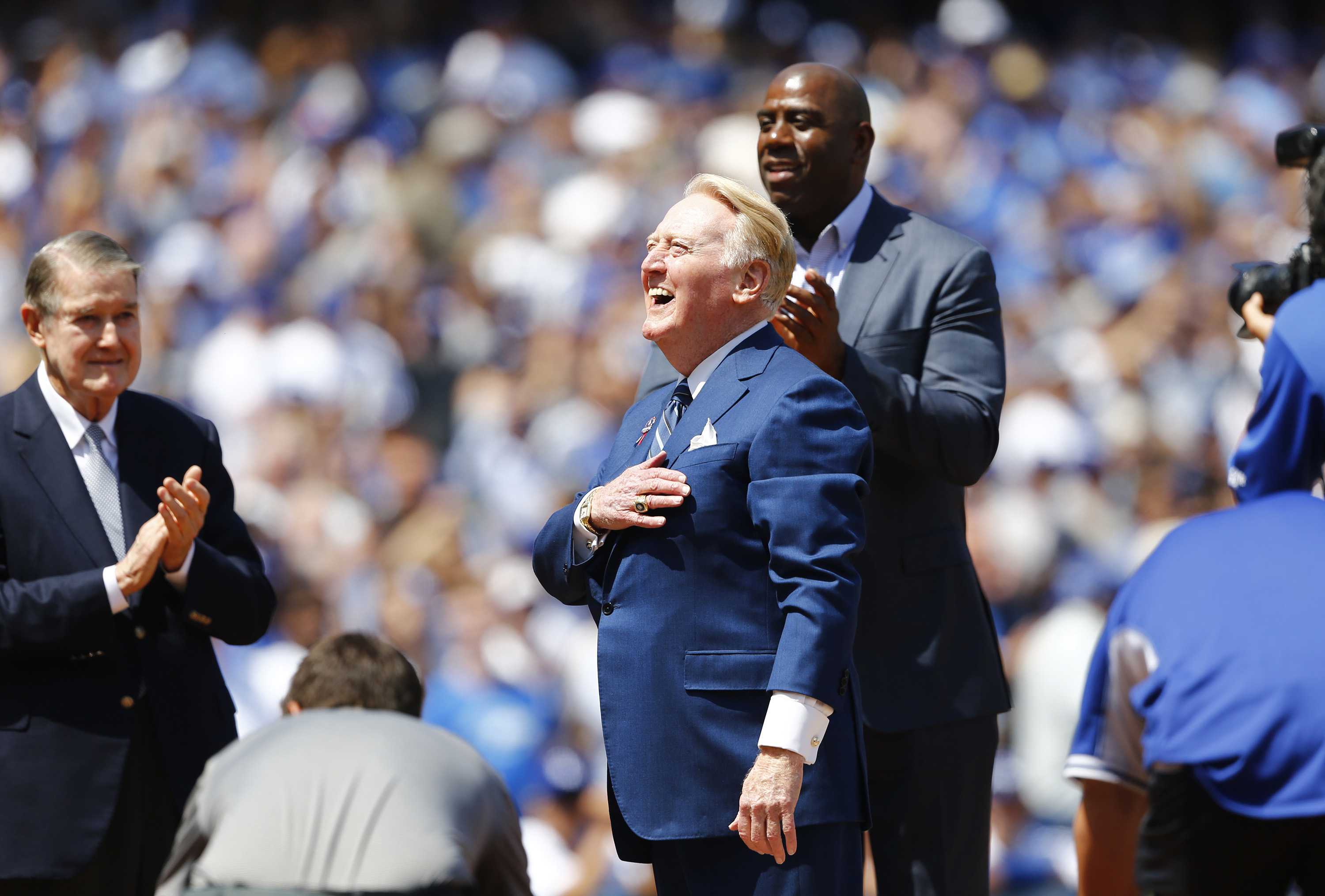 Los Angeles Dodgers announcer Vin Scully is honored at home plate in a pregame ceremony on his last Opening Day, on Tuesday, April 12, 2016, at Dodger Stadium in Los Angeles. Former Dodgers owner Peter O'Malley, left, and Magic Johnson, top, are also on hand. (Gina Ferazzi/Los Angeles Times/TNS/MCT)