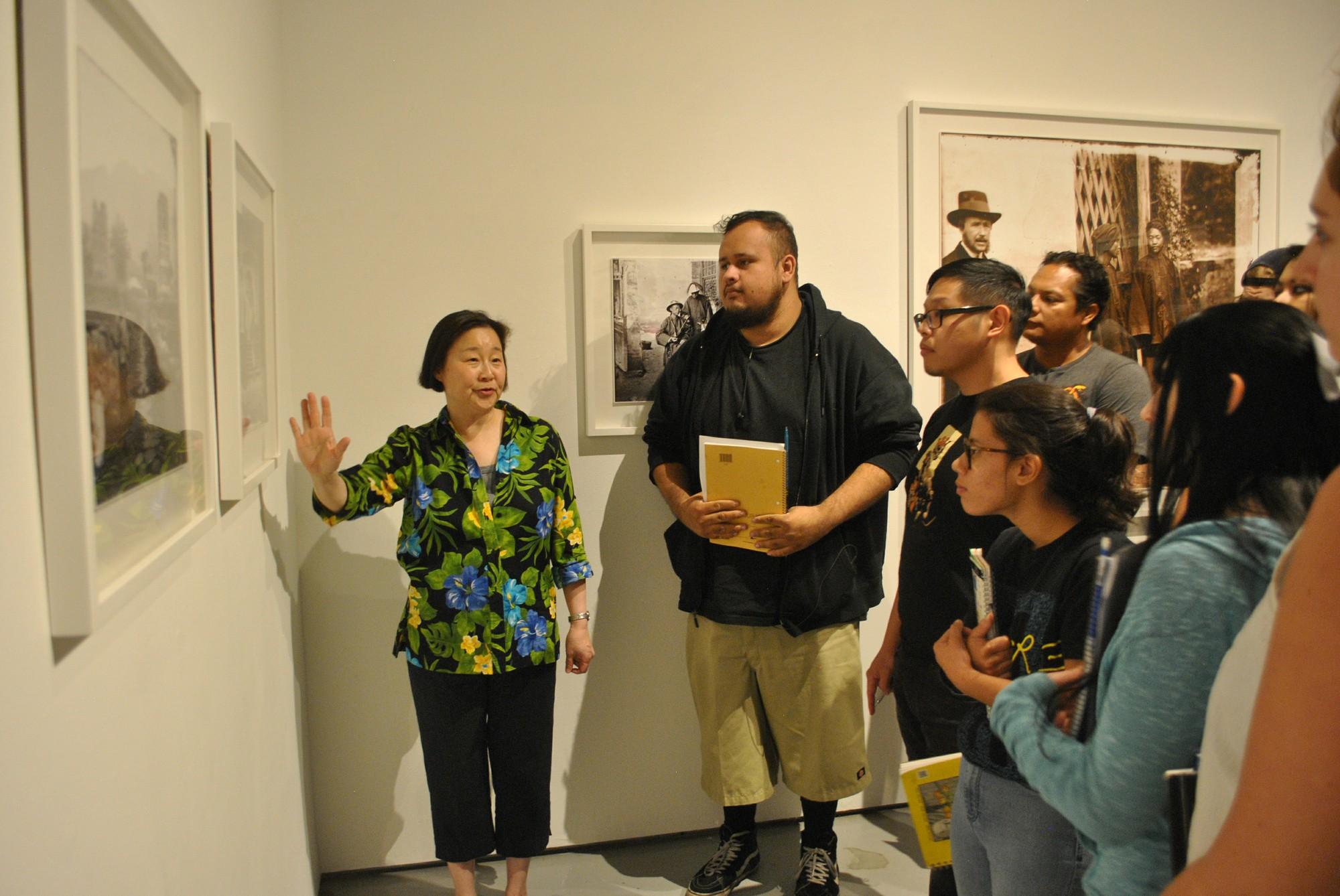 Exhibit curator explains a photo at a museum