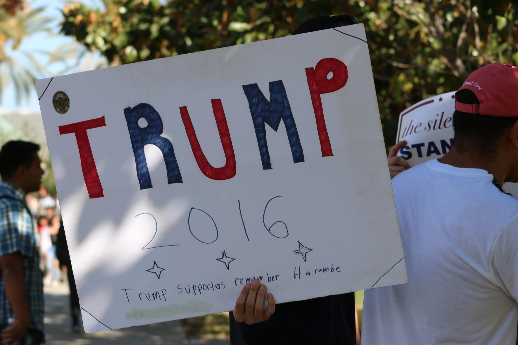 Trump supporters held up signs near the Matador Statue. Photo Credit,Meliss Arteaga