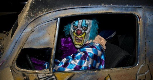 Creepy clown pictured inside beat-up car
