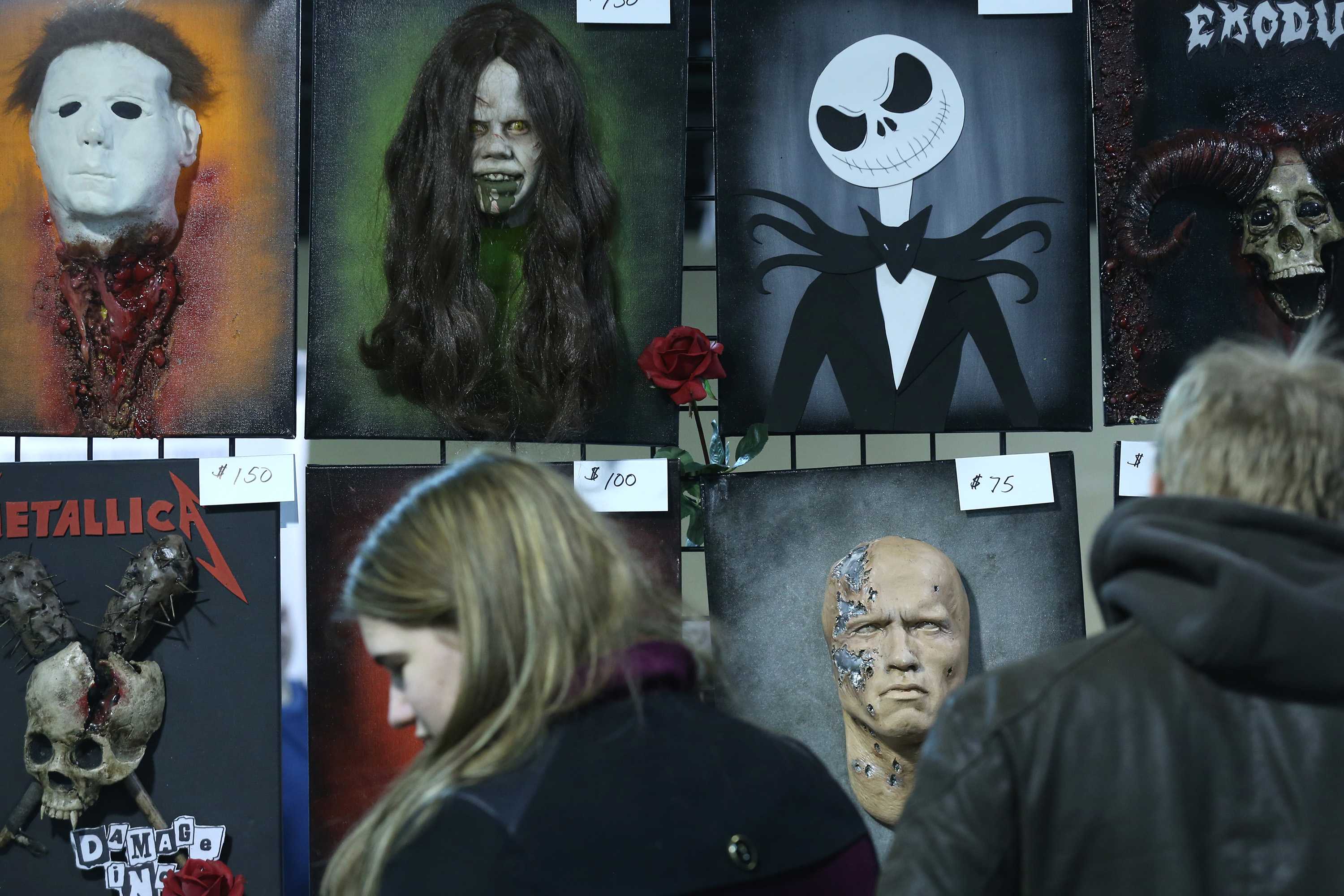 Attendees view masks of horror film characters during the Mad Mobster True Crime and Horror Expo at the Chicago Hilton and Towers Saturday, Feb. 14, 2015, in Chicago.
(John J. Kim/Chicago Tribune/TNS/MCT)