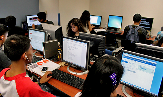 Students shown working on computers