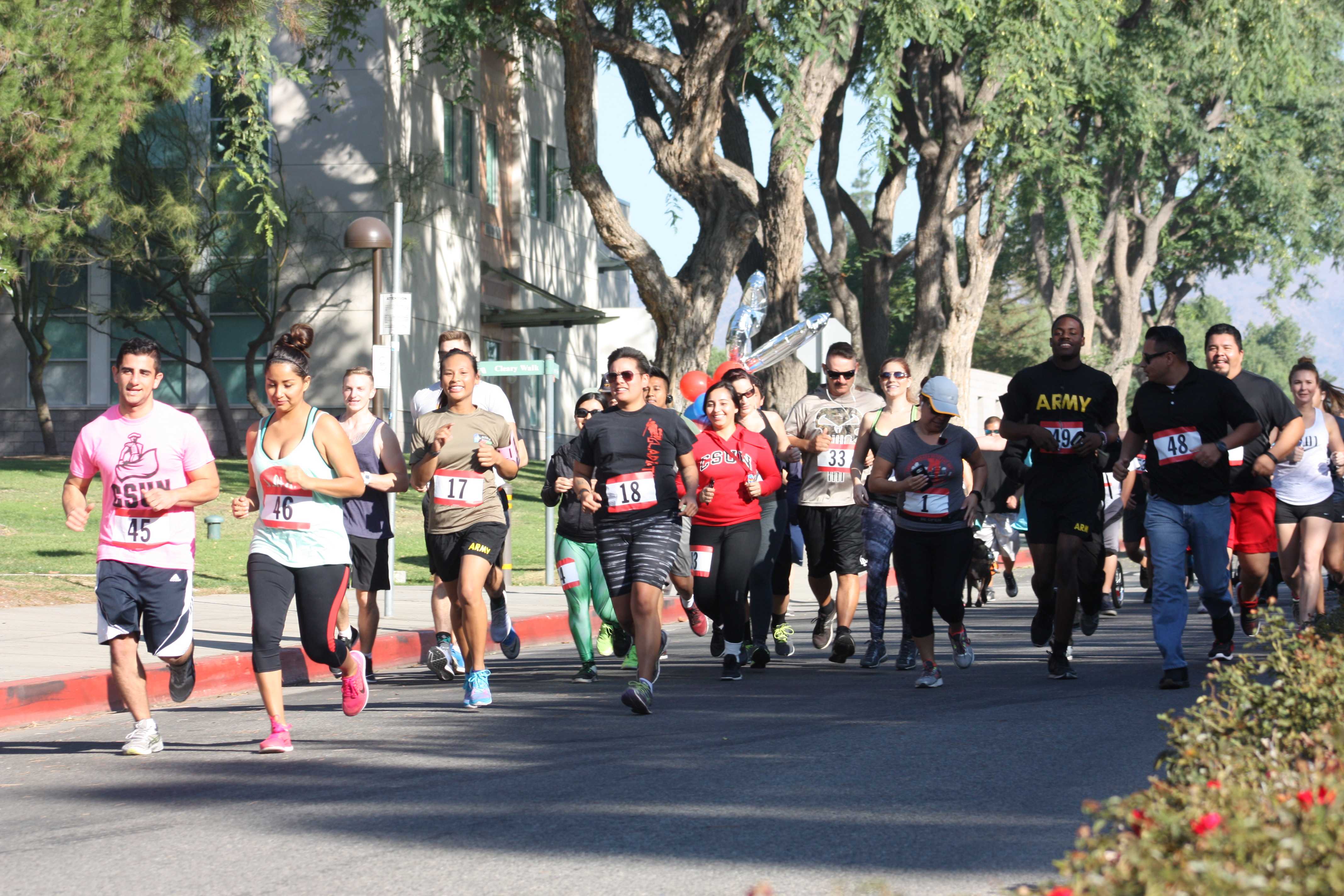Fun Runners take off from the starting line down University Drive Sunday Morning. Photo credit: America Garza