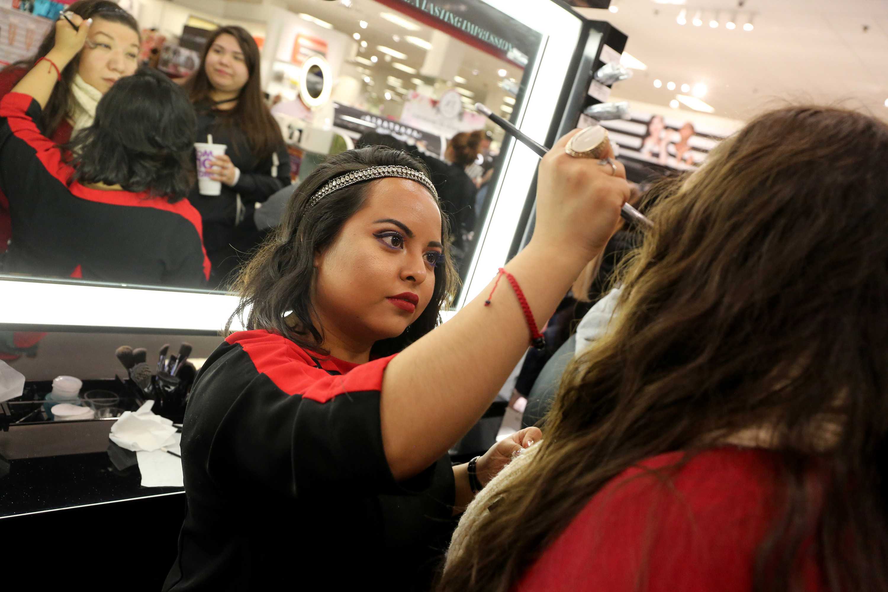 Sephora employee applies makeup on customer