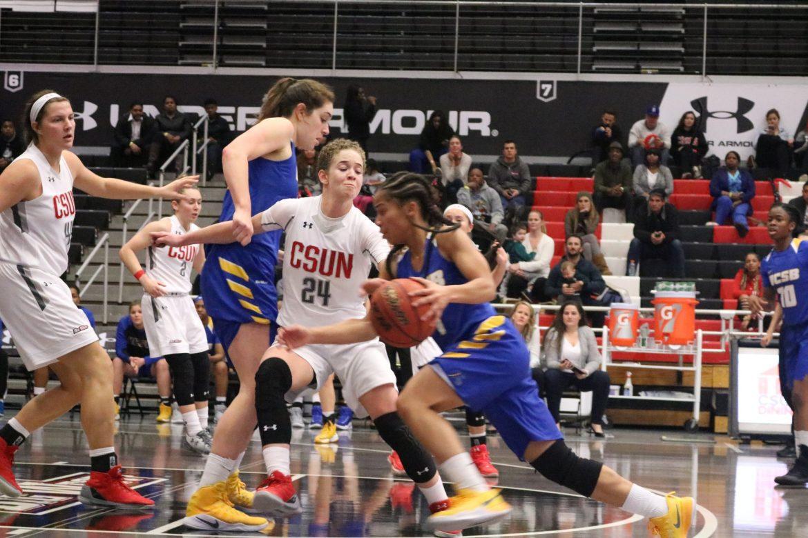 UCSB has the ball at center court and CSUN player is blocking her