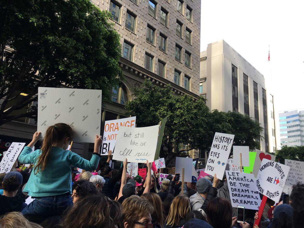 Thousands of marchers gather at Pershing Square with signs. Photo credit: Meliss Arteaga