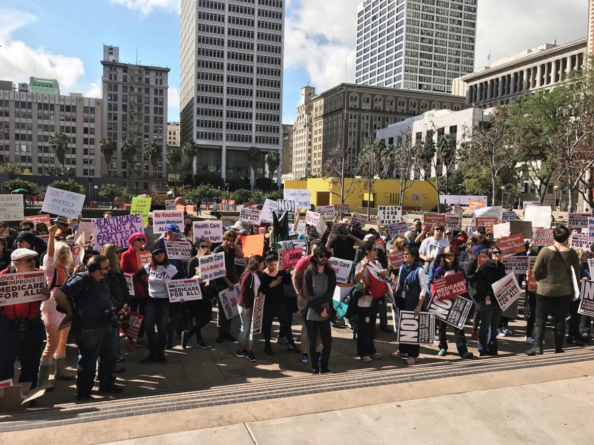 Protesters wave their picket signs at Pershing Square