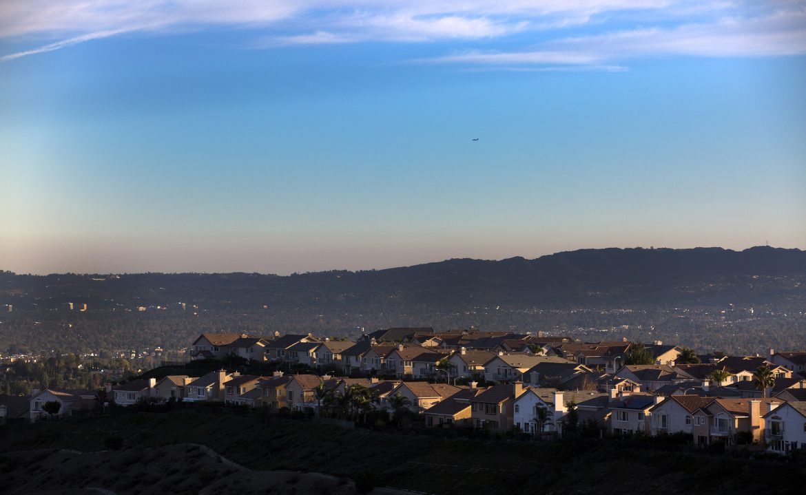 The late afternoon sun casts a warm glow on ridgeline homes overlooking the San Fernando Valley on Dec. 23, 2015 in Porter Ranch, Calif. (Brian van der Brug/Los Angeles Times/TNS)