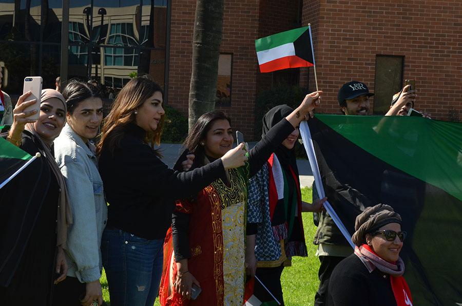 Students sang while the Kuwaiti flag was being held up on the lawn between the Matador Bookstore Complex and Santa Susana Hall on Wednesday, Feb. 23, 2017. They were participating in a Kuwait Liberation Day celebration. Photo credit: Anthony Martinez