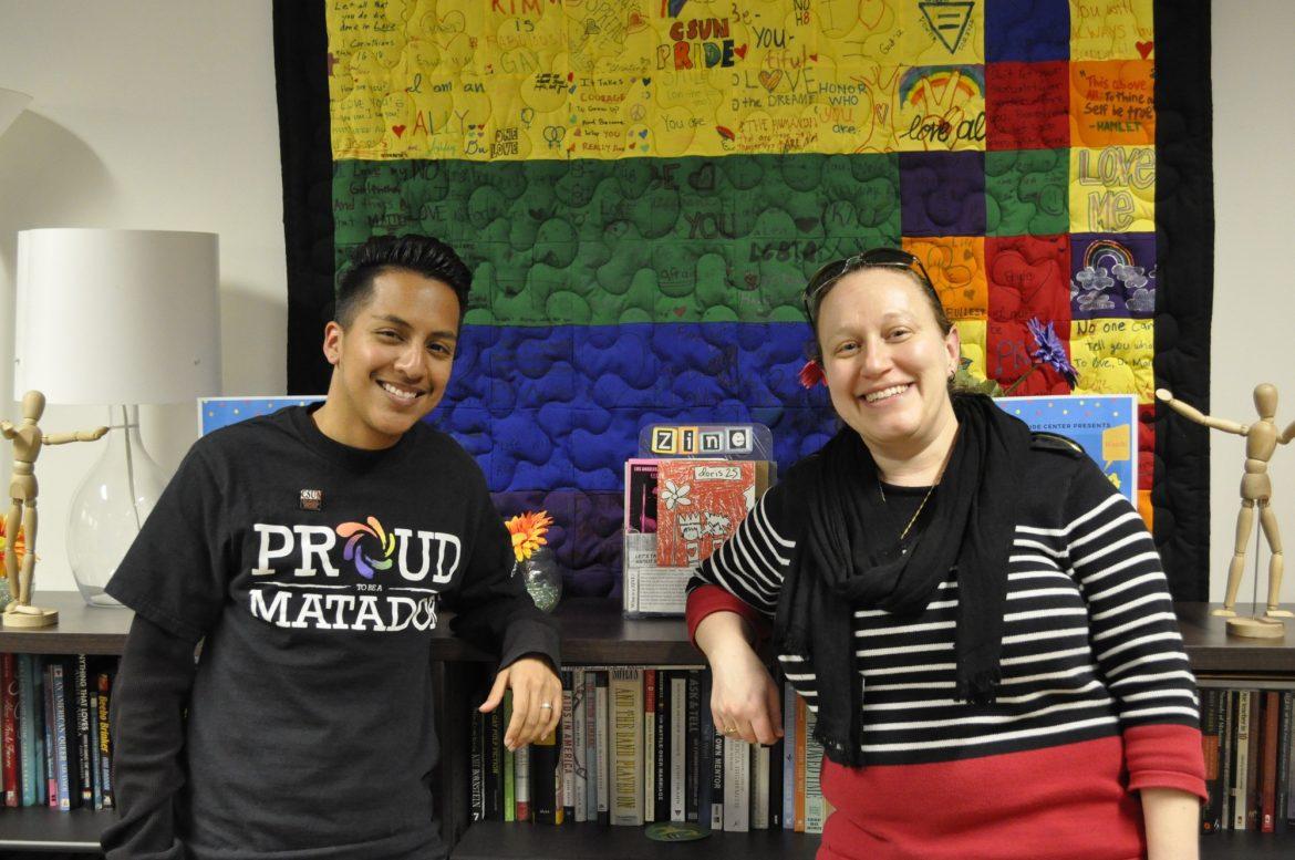 two students pose for a picture in the pride center