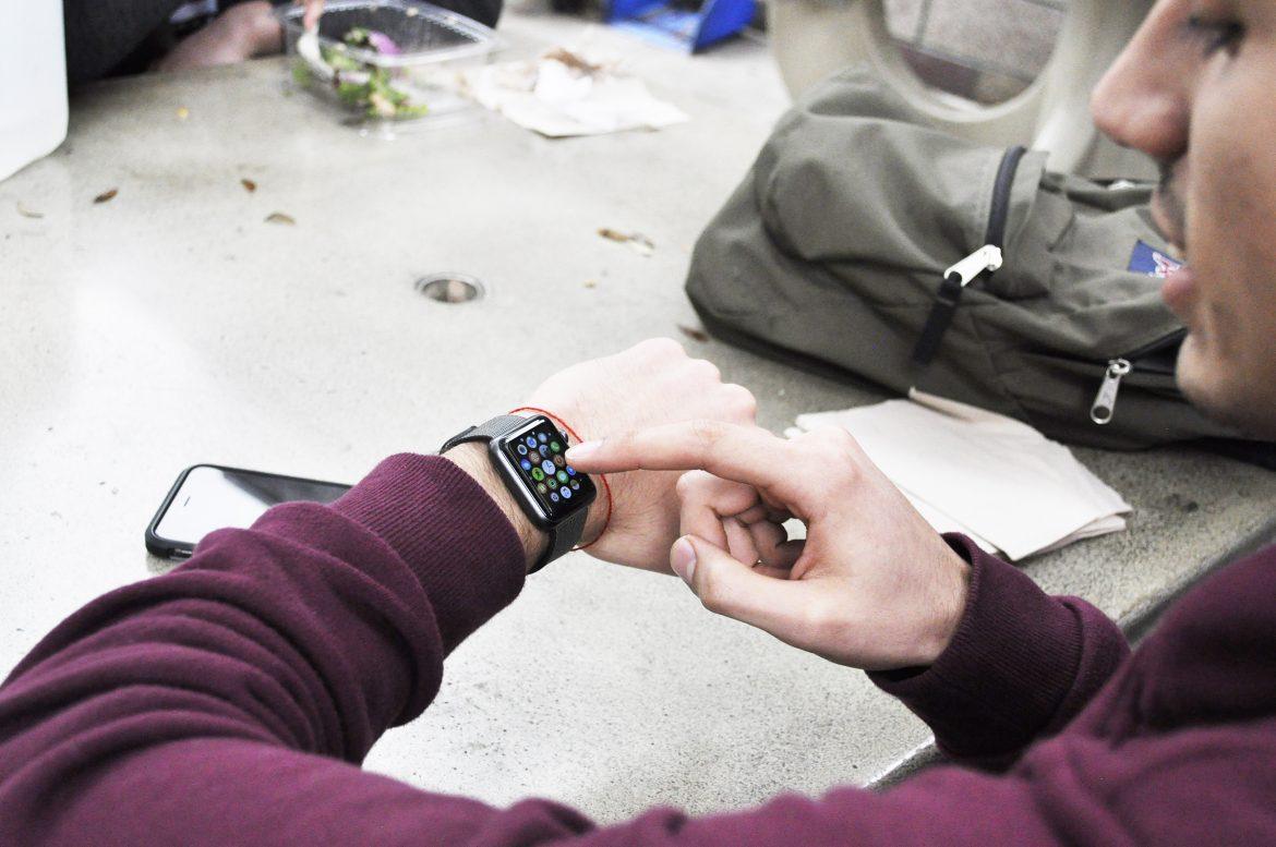 Student pictured while using his smartwatch
