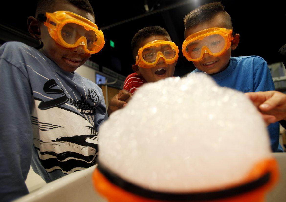 Students in an October 2011 file image react during a science experiment in first grade class at Alexander Science Center School in Los Angeles, learning about three states of matter: gas, liquid, and solid. New education guidelines in the state call for an increase in hands-on learning opportunities. (Francine Orr/Los Angeles Times/TNS)