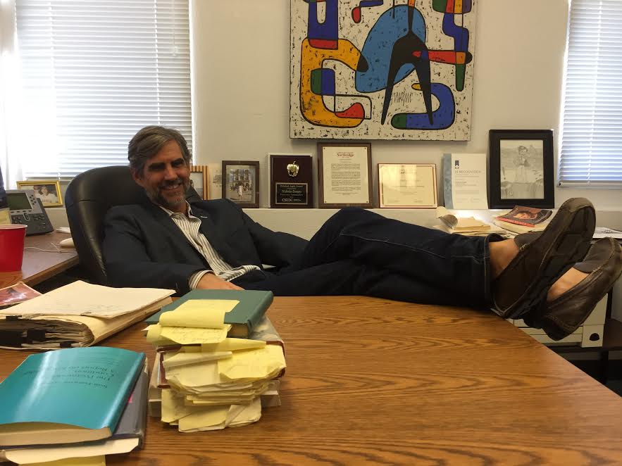 Professor+Dungey+pictured+in+his+office+with+his+feet+rested+on+his+desk