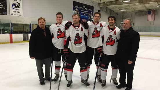 Several members of the matador hockey team pose for a photo on the ice