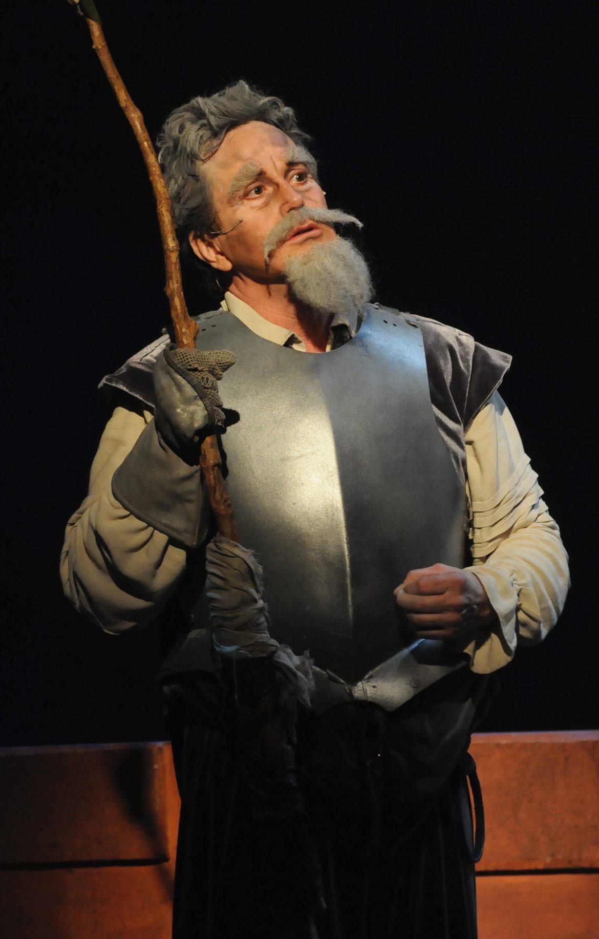 Man wears armor along with some fake facial hair to play Don Quixote