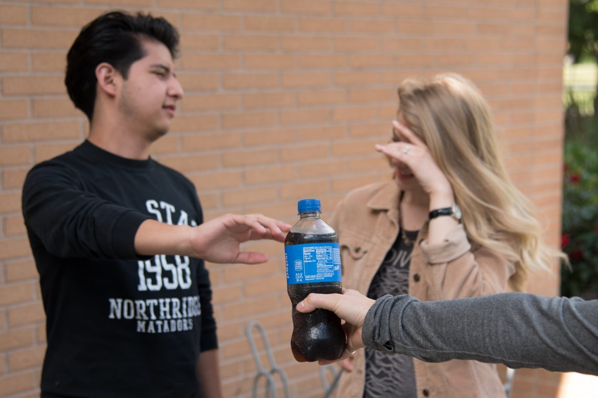 two+students+pictured+refusing+a+bottle+of+pepsi