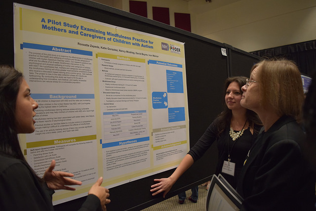 BUILD PODER scholars Roxxette Zepeda (public health) and Katie Gonzalez (psychology) present their research project, “A Pilot Study Examining Mindfulness Practice for Mothers and Caregivers of Children with Autism” at the 2016 CSUN Annual Student Research and Creative Works Symposium. (Also appearing in the photo is one of the principal investigators of the grant, psychology professor Carrie Saetermoe). Photo Courtesy: BUILD PODER