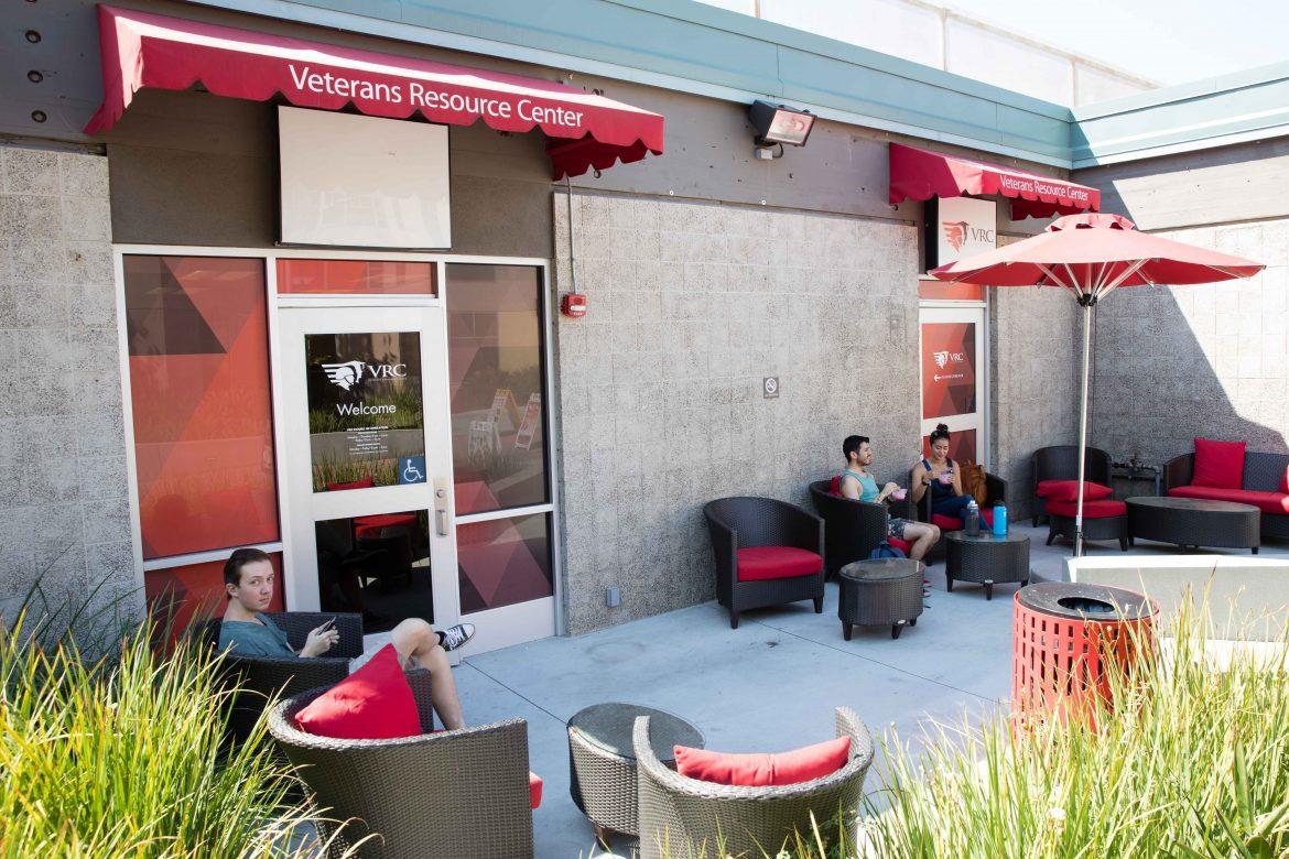 Exterior of veterans resource center pictured with red awnings and plenty of chairs