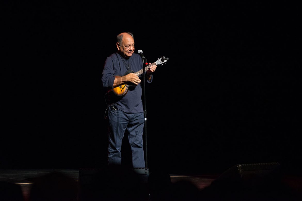 Cheech Marin plays an electric ukelele while singing 
