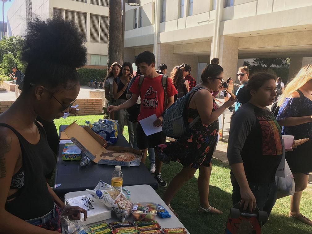 Frustrated students handed out free waters and snacks in hopes to stop students from buying on campus. Photo credit: Dede Ogbueze