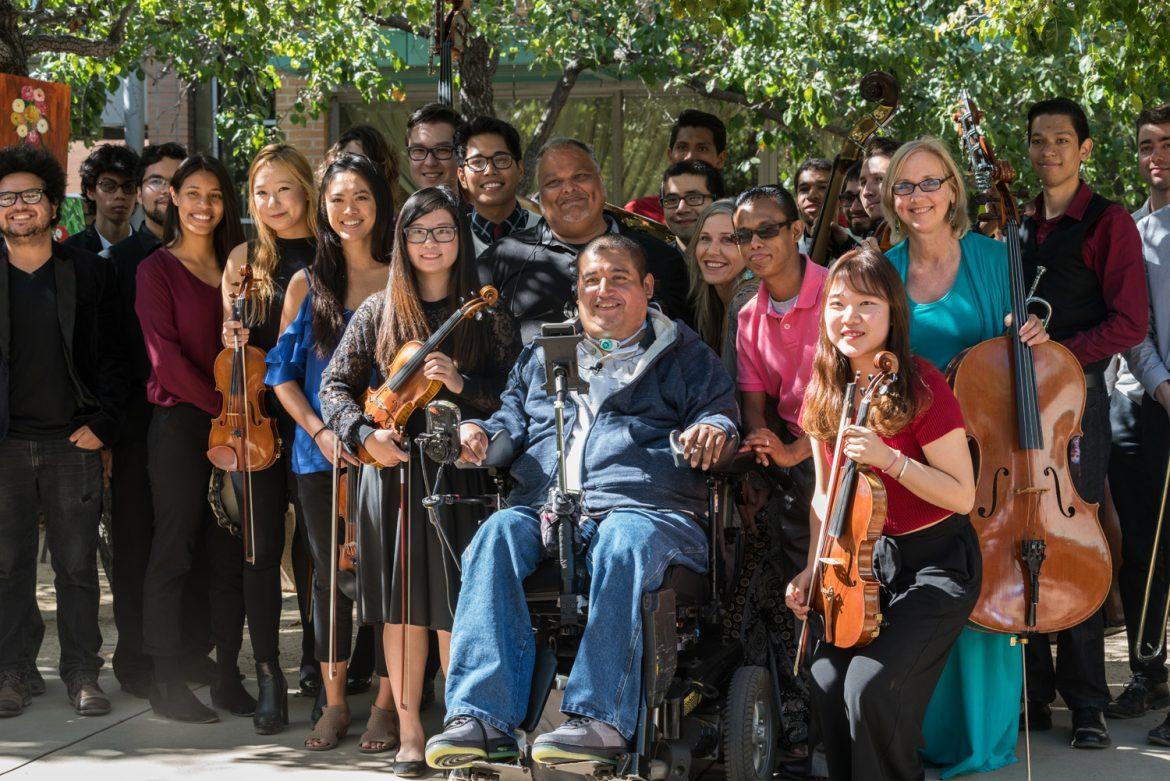 musicians posing for a photo with violins and cellos