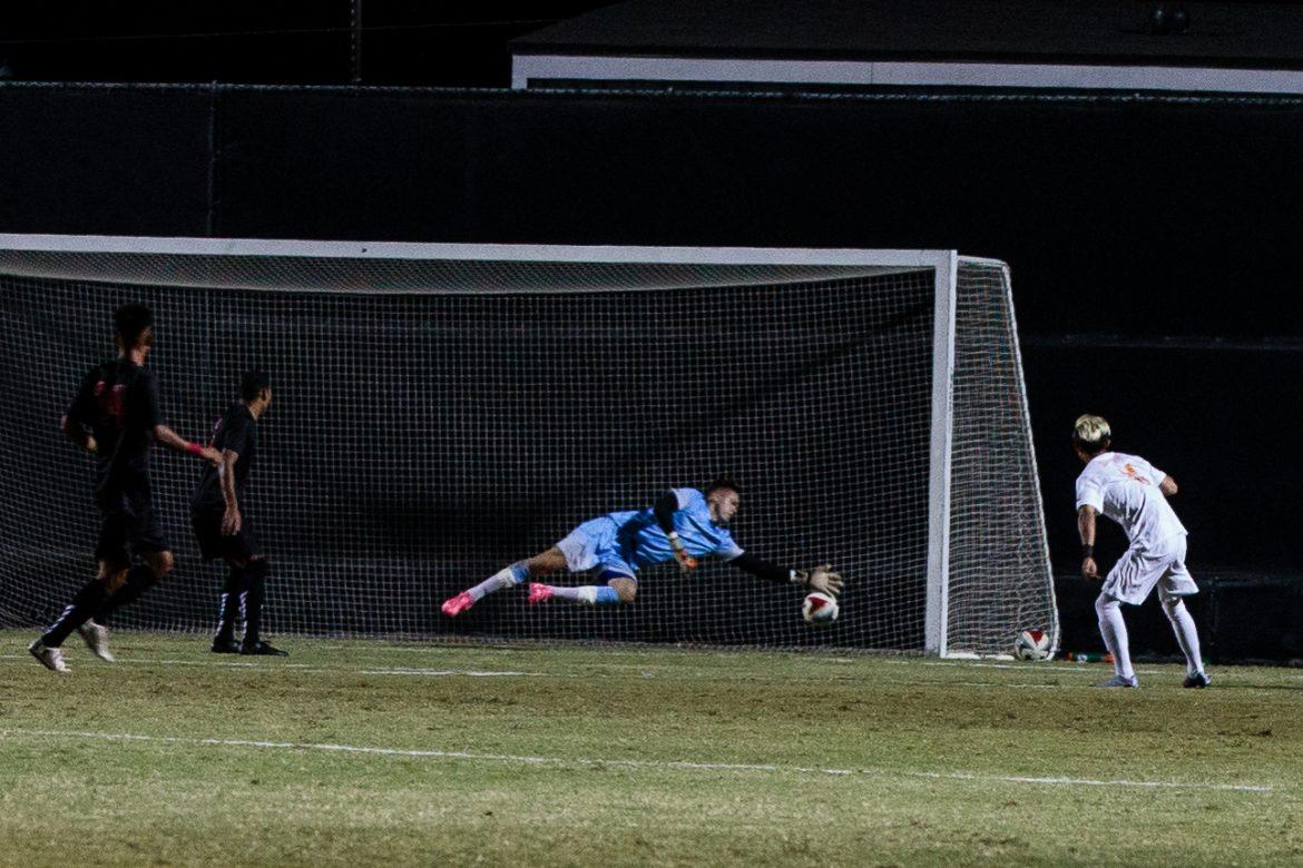 CSUN goalie in blue tries to stop a ball